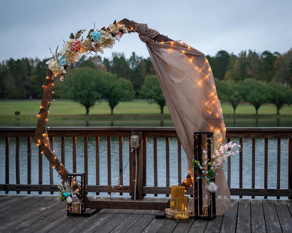 modern wedding arch with colorful summer flowers