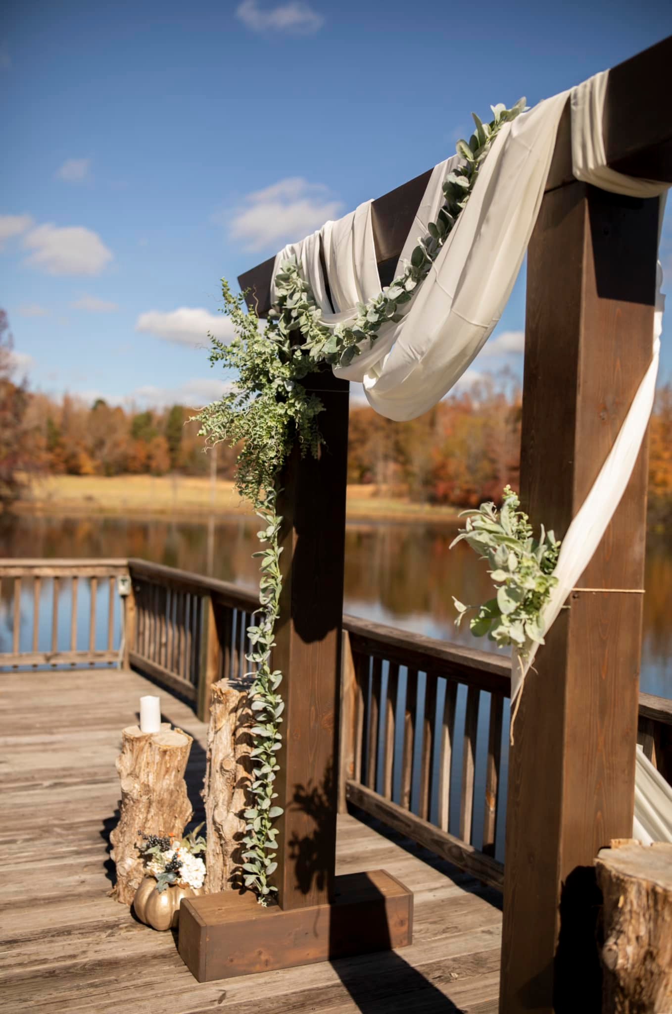 modern wedding arch with greenery draping across