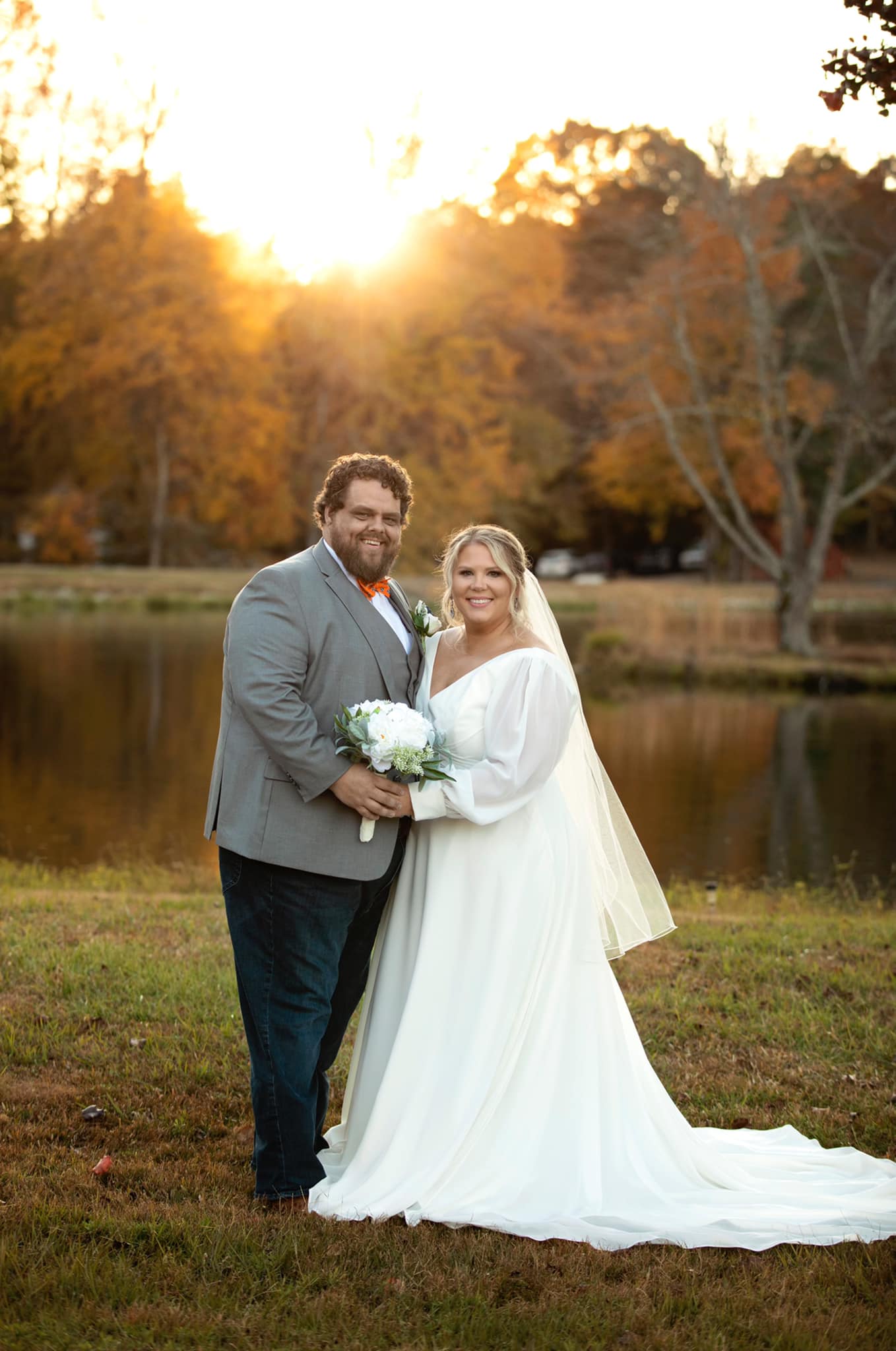 bride and groom pose at sunset