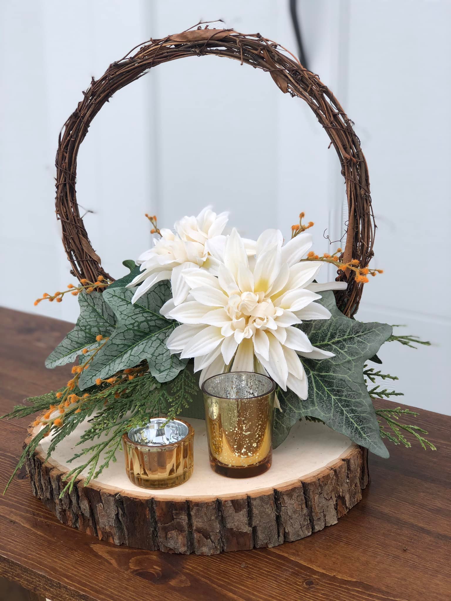 wedding decorations with white flowers and wooden wreath