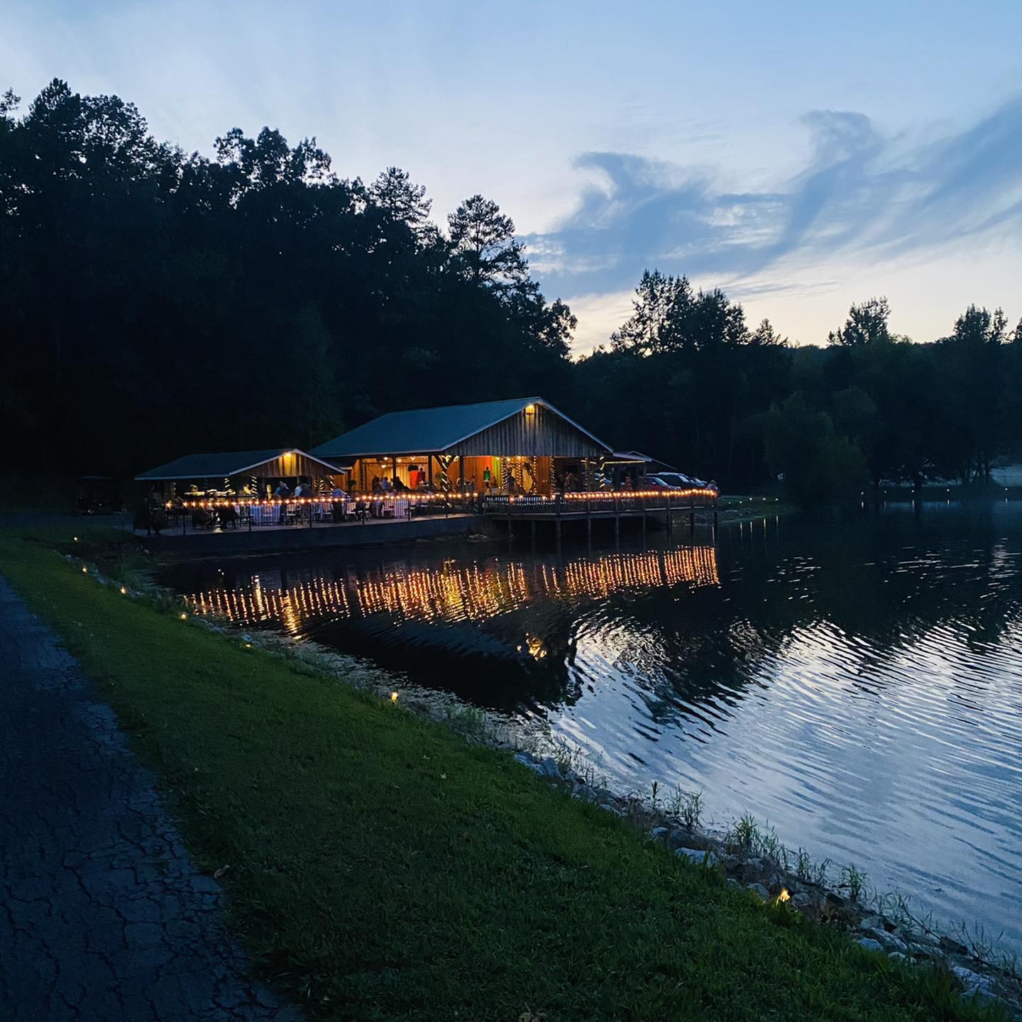 lit up outdoor wedding pavilion overlooking lake