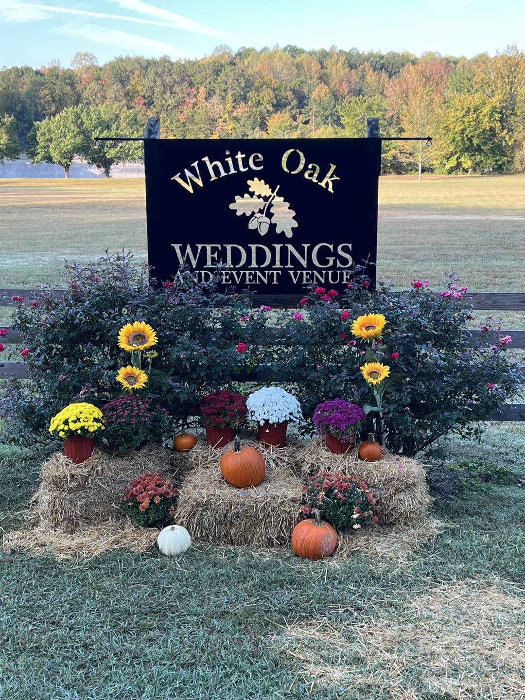 wedding venue sign surrounded by fall decorations