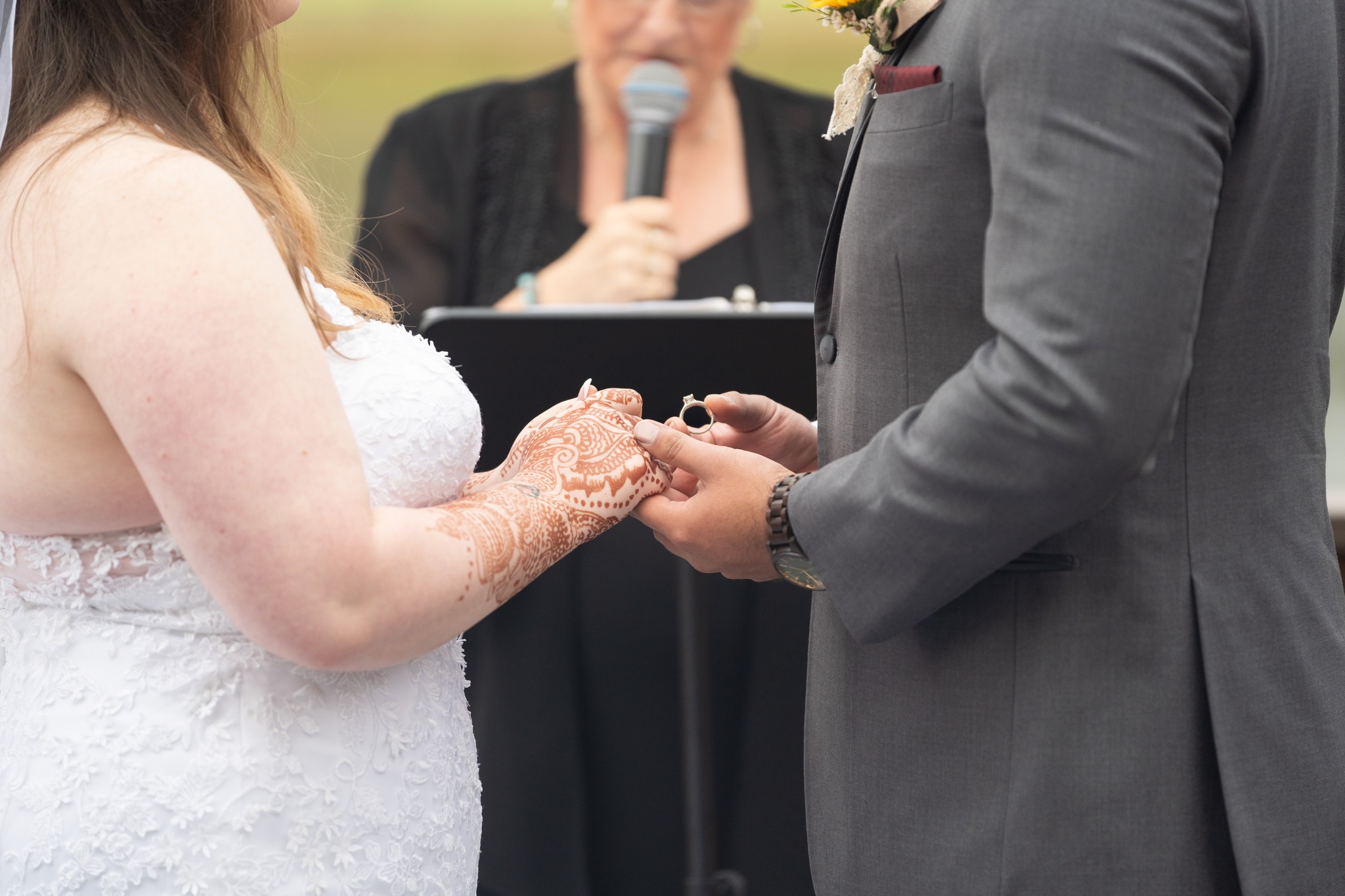 groom presents ring to bride