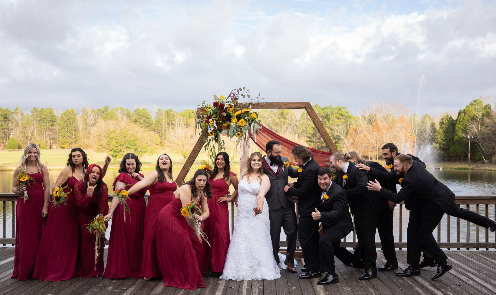 bride and groom with wedding party in red and yellow theme