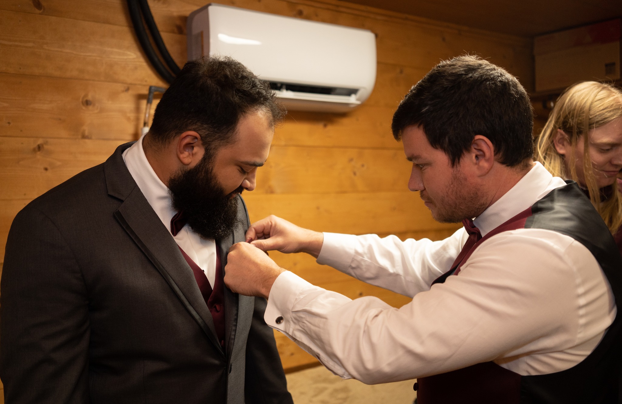 groomsmen fixing grooms pocket handkerchief