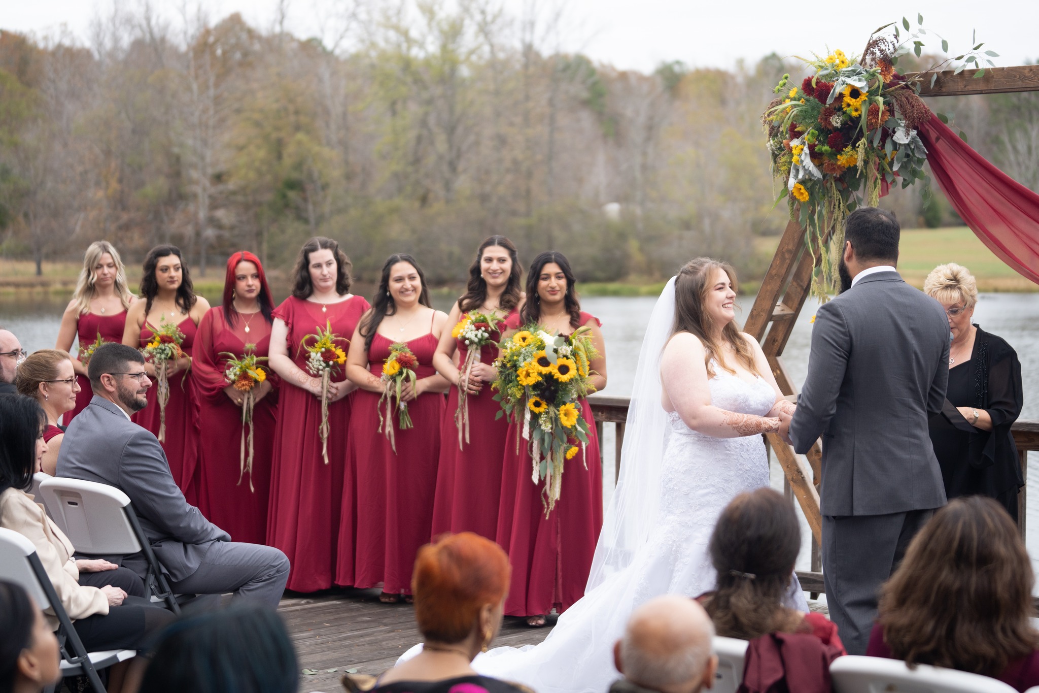 bride smiling at groom while bridesmaids oversee