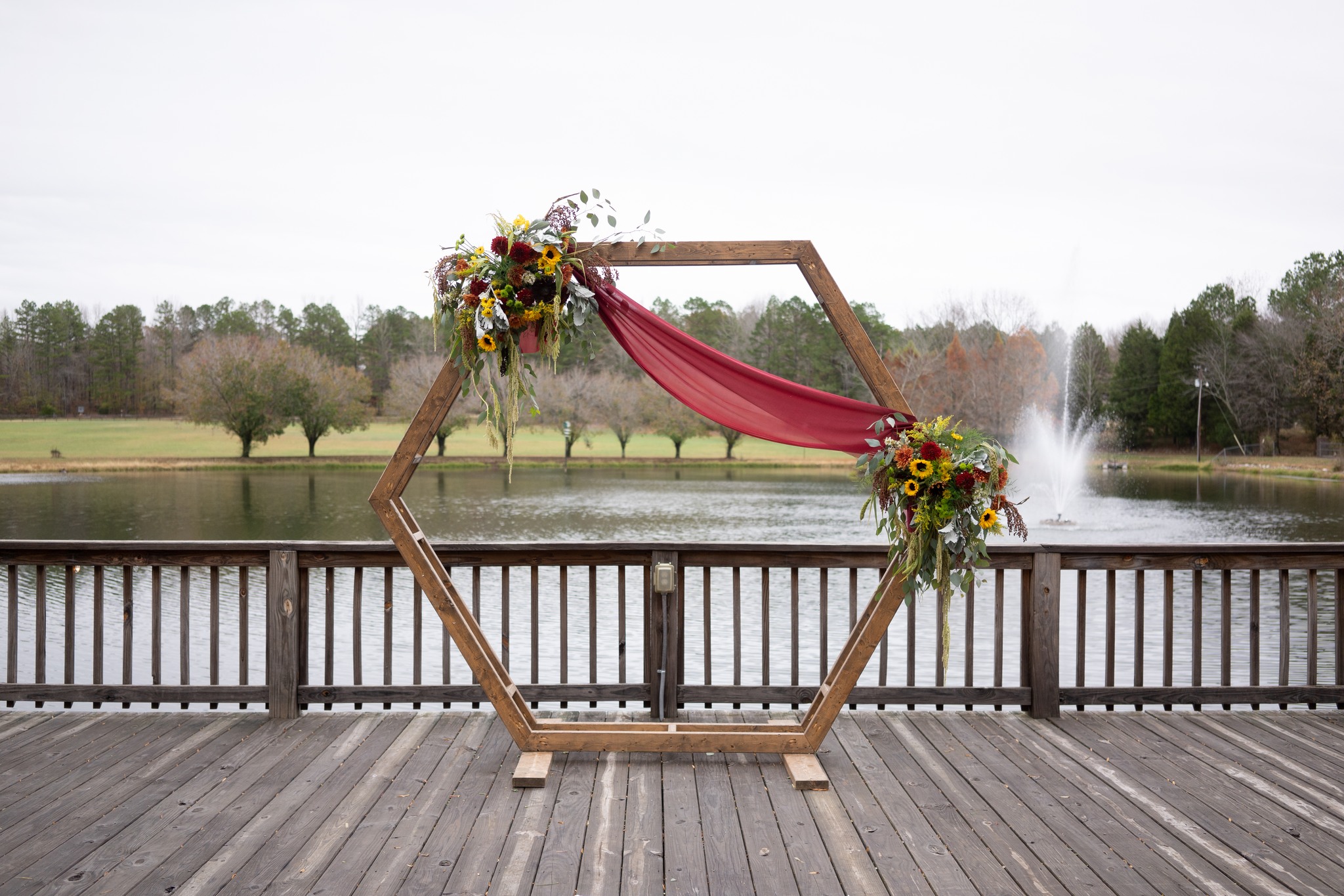 wedding arch with red and yellow flowers