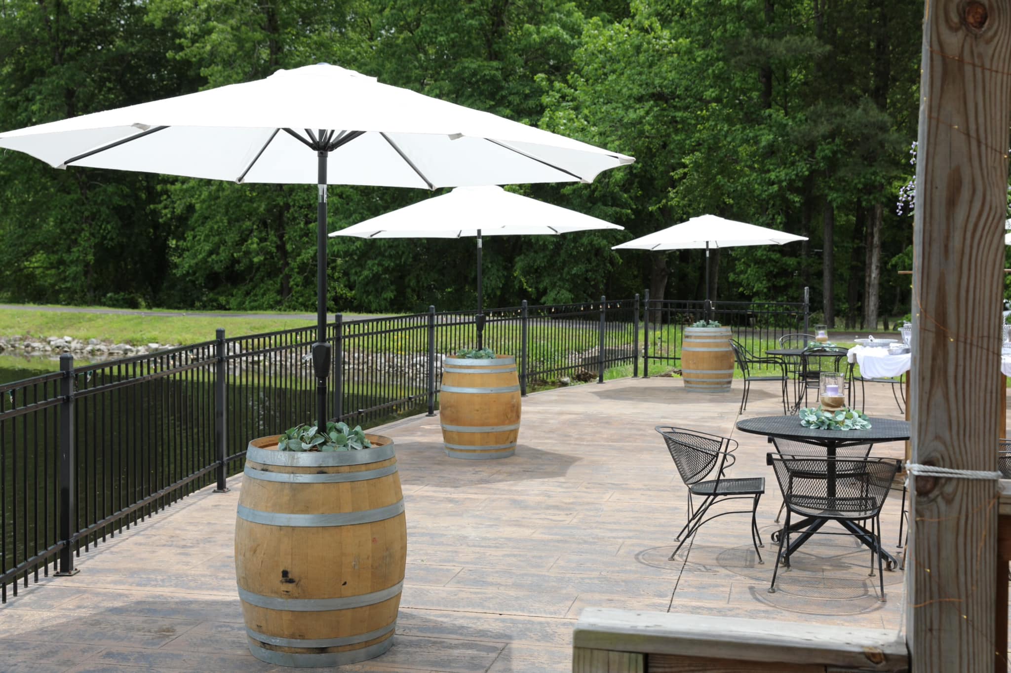 barrels holding umbrellas on outdoor venue deck