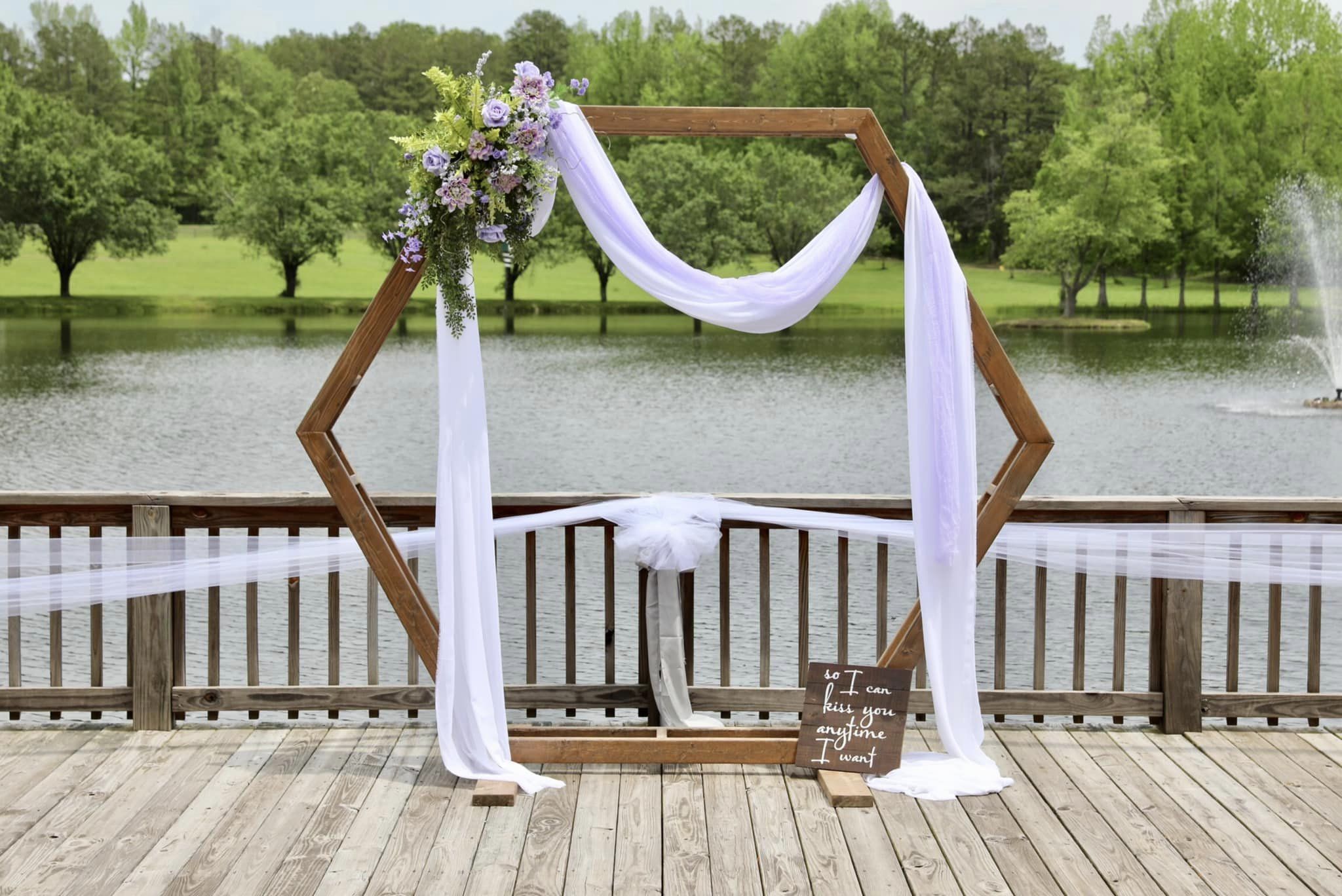 modern hexagonal arch with light purple draping and flowers