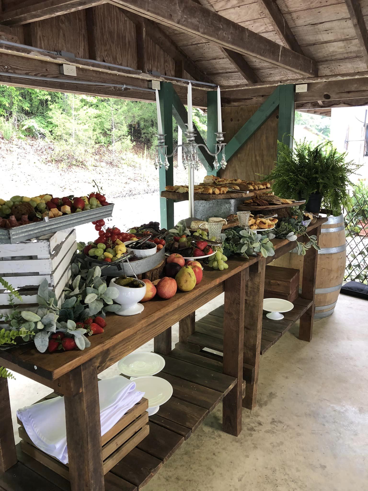 rustic wedding finger foods serving table with greenery and crystals