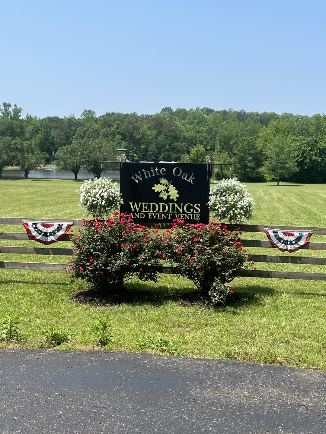 wedding venue sign with rose bushes
