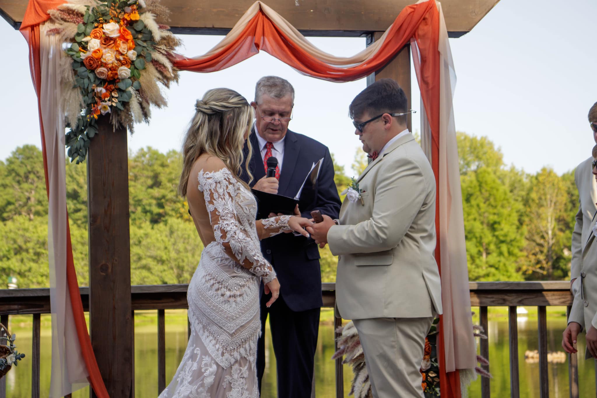 groom presents ring to bride