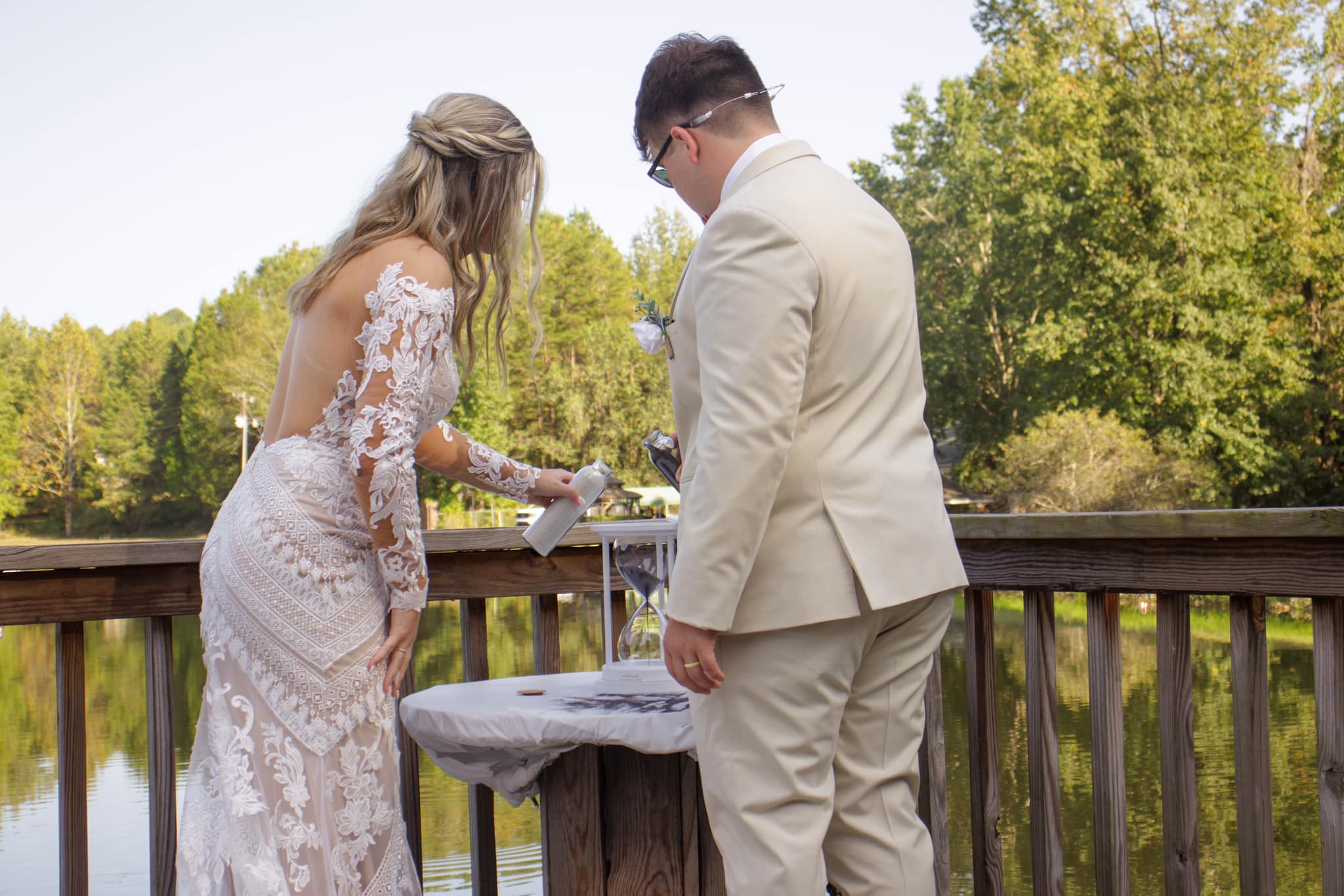 bride and groom combine sand into hourglass