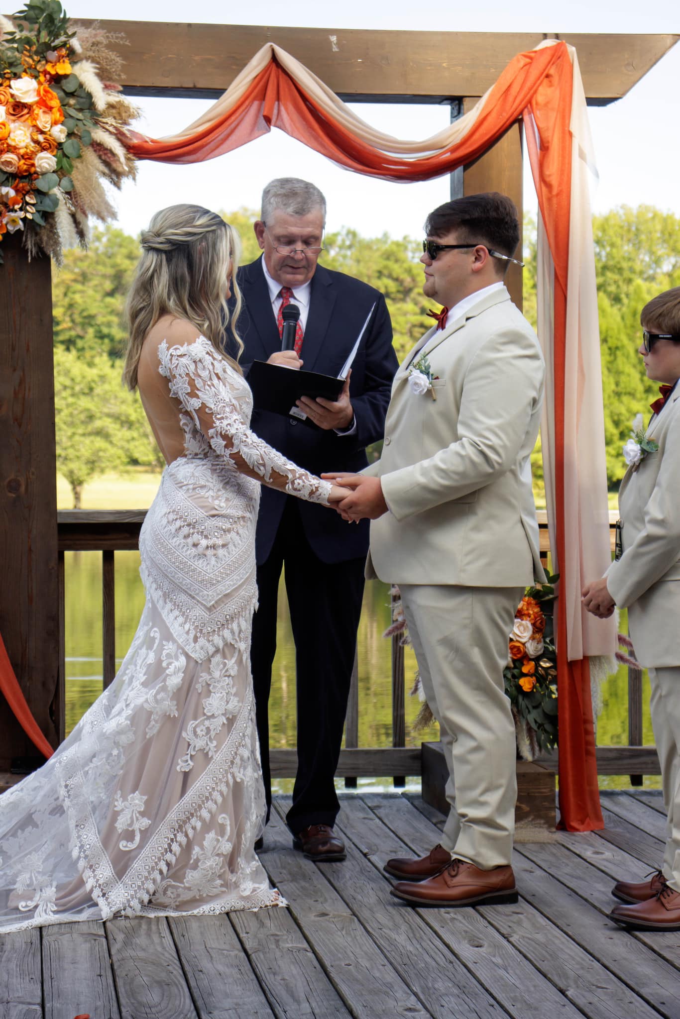 bride and groom listen to officiant read