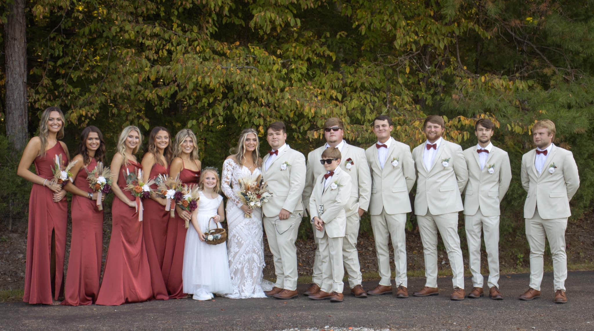 bride and groom with wedding party, flower girl, and ring bearer