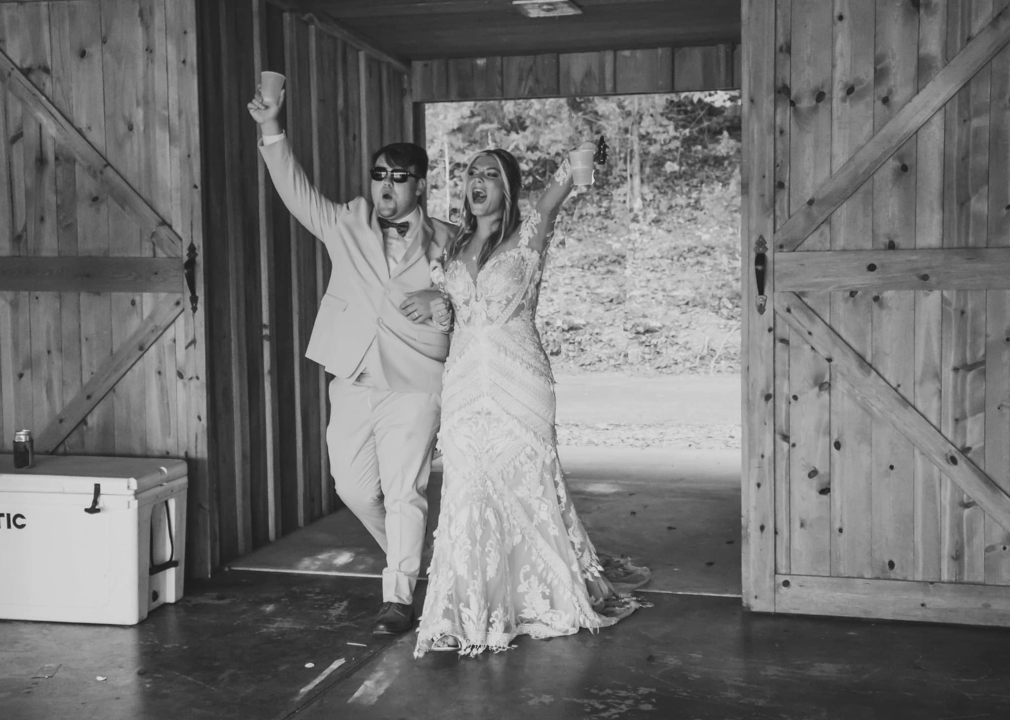 bride and groom celebrate while entering reception
