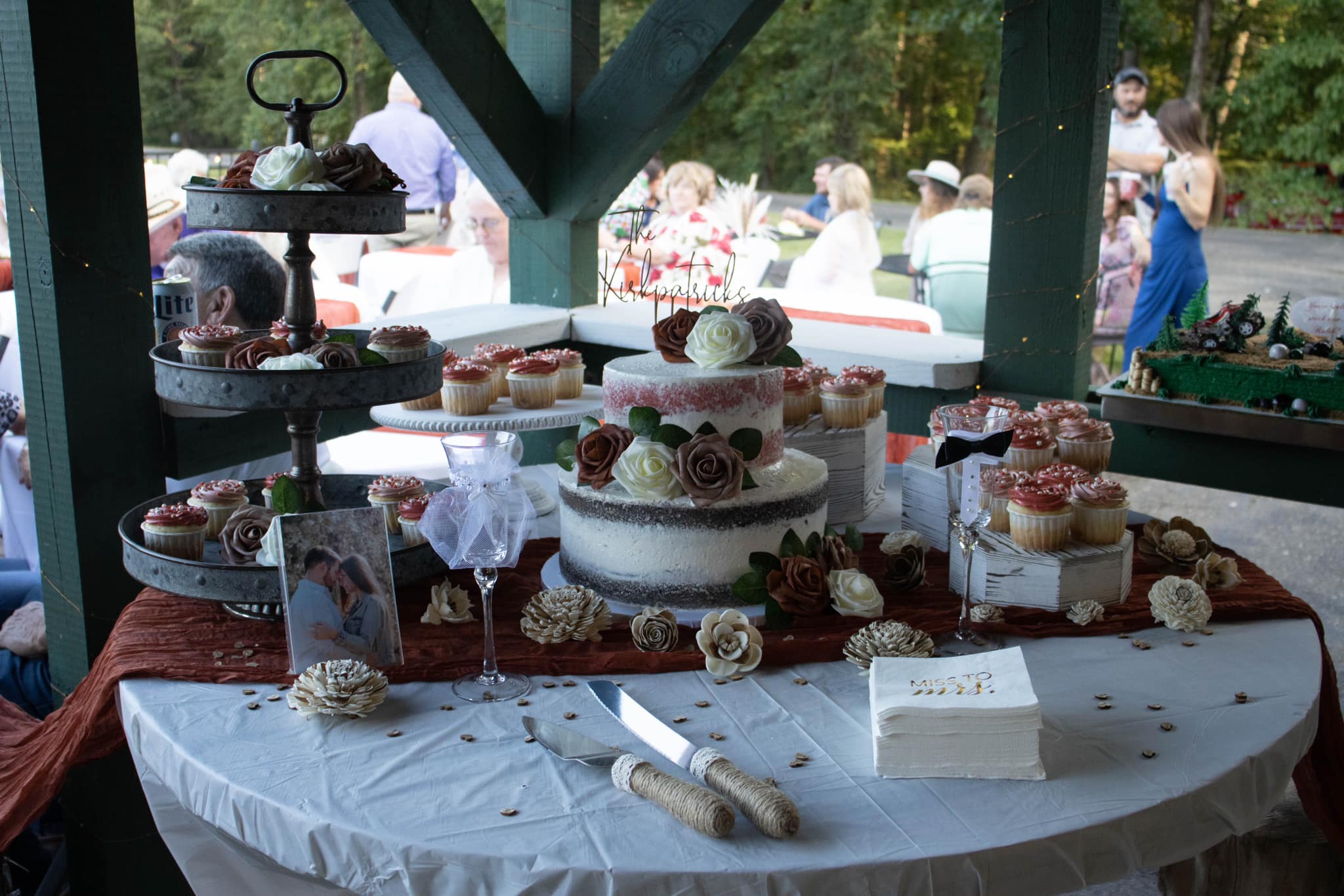 wedding cake and cupcake with orange and gold decorations