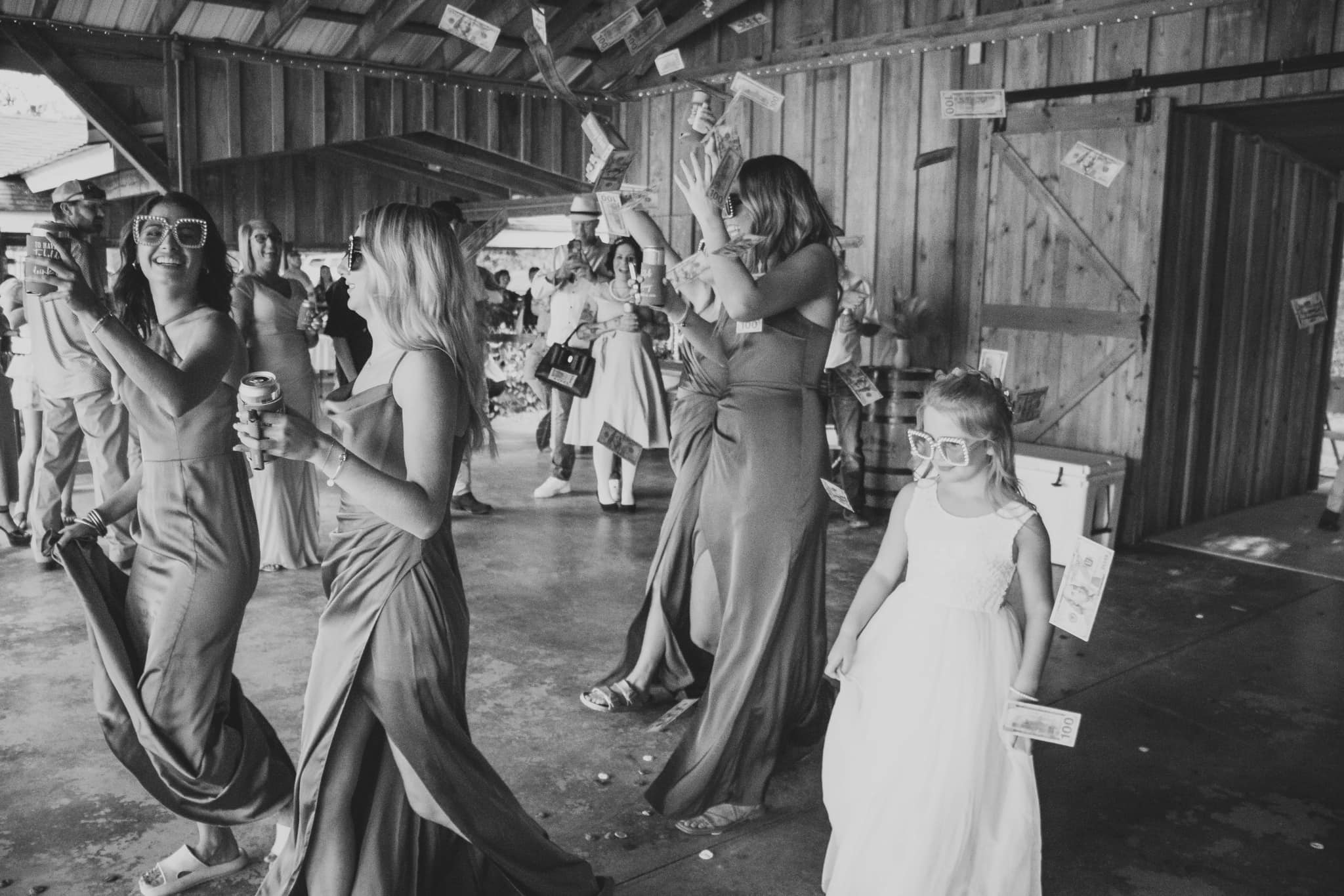 bridesmaids celebrating with money gun at reception