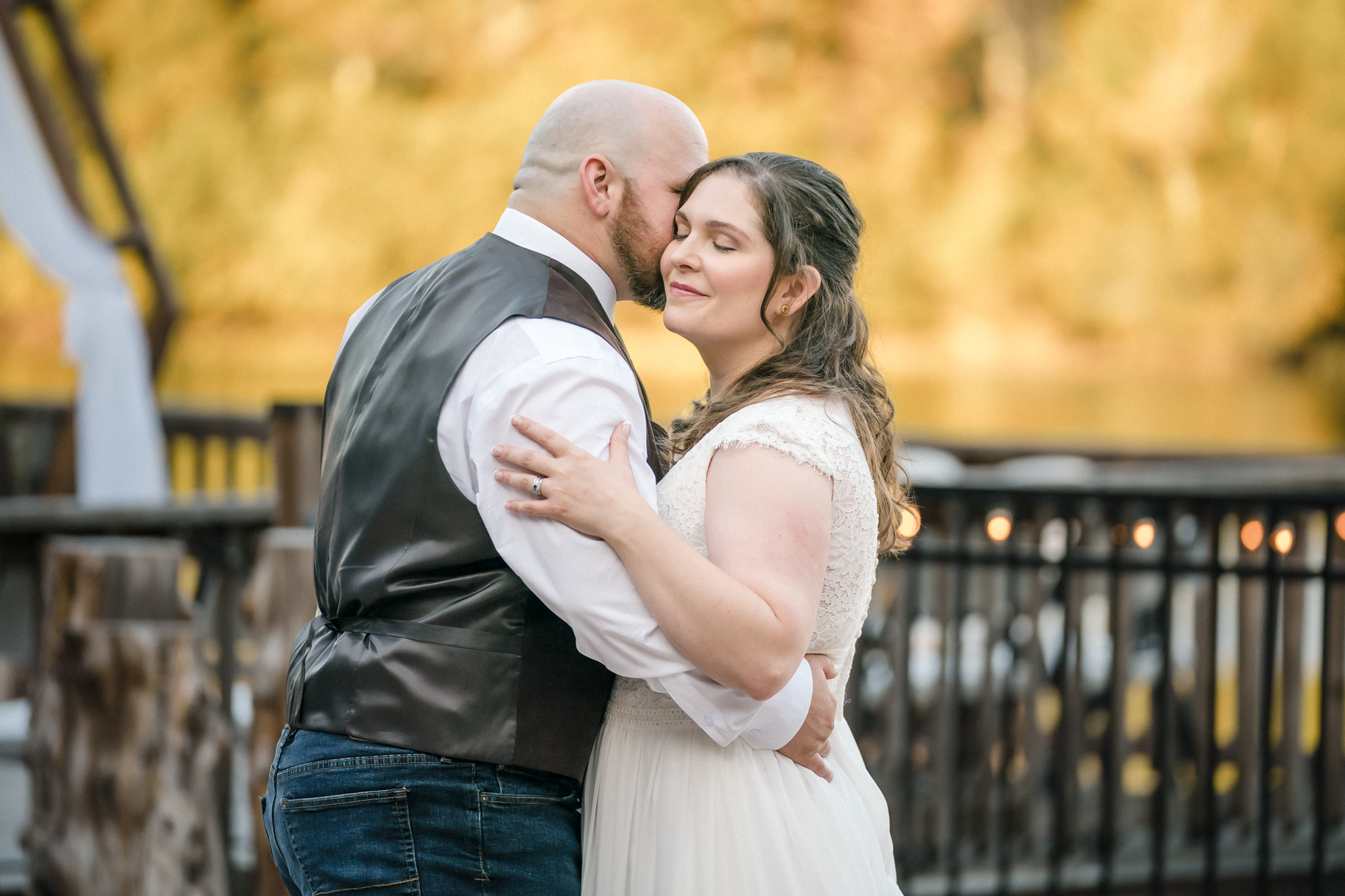 groom kisses bride on the cheek