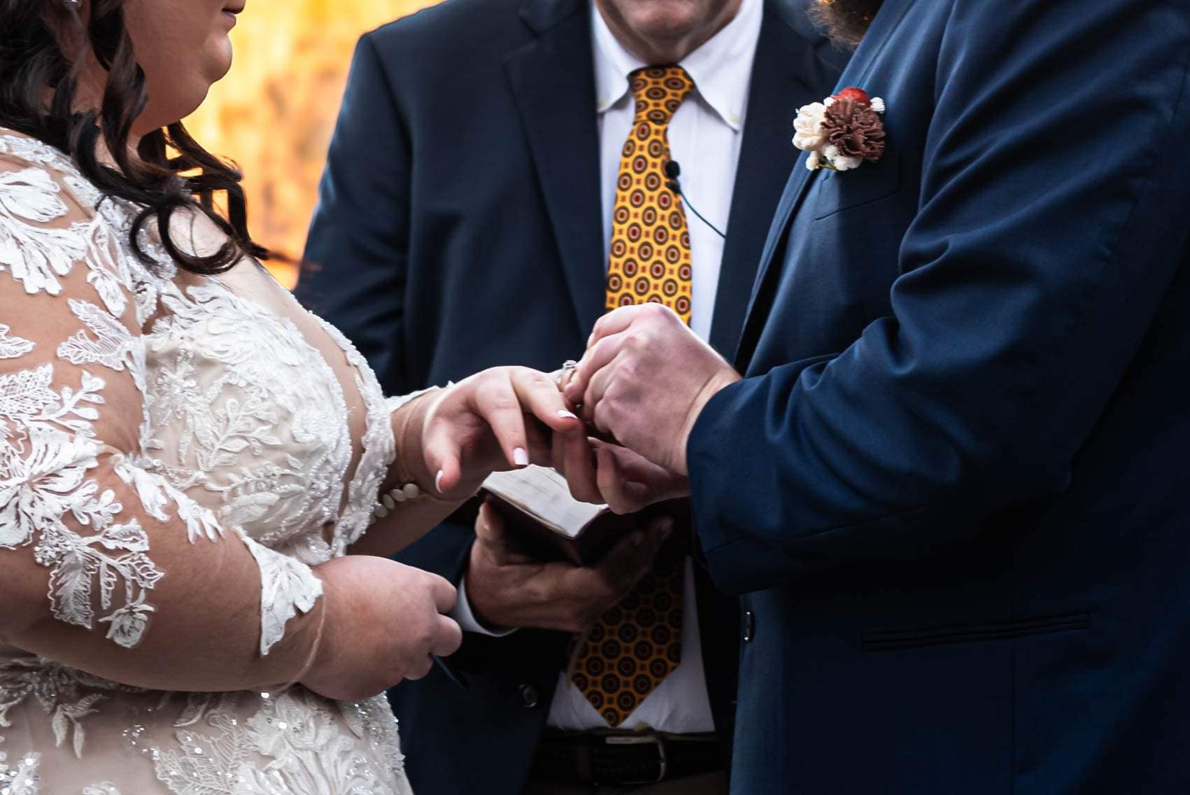 groom presents ring to bride