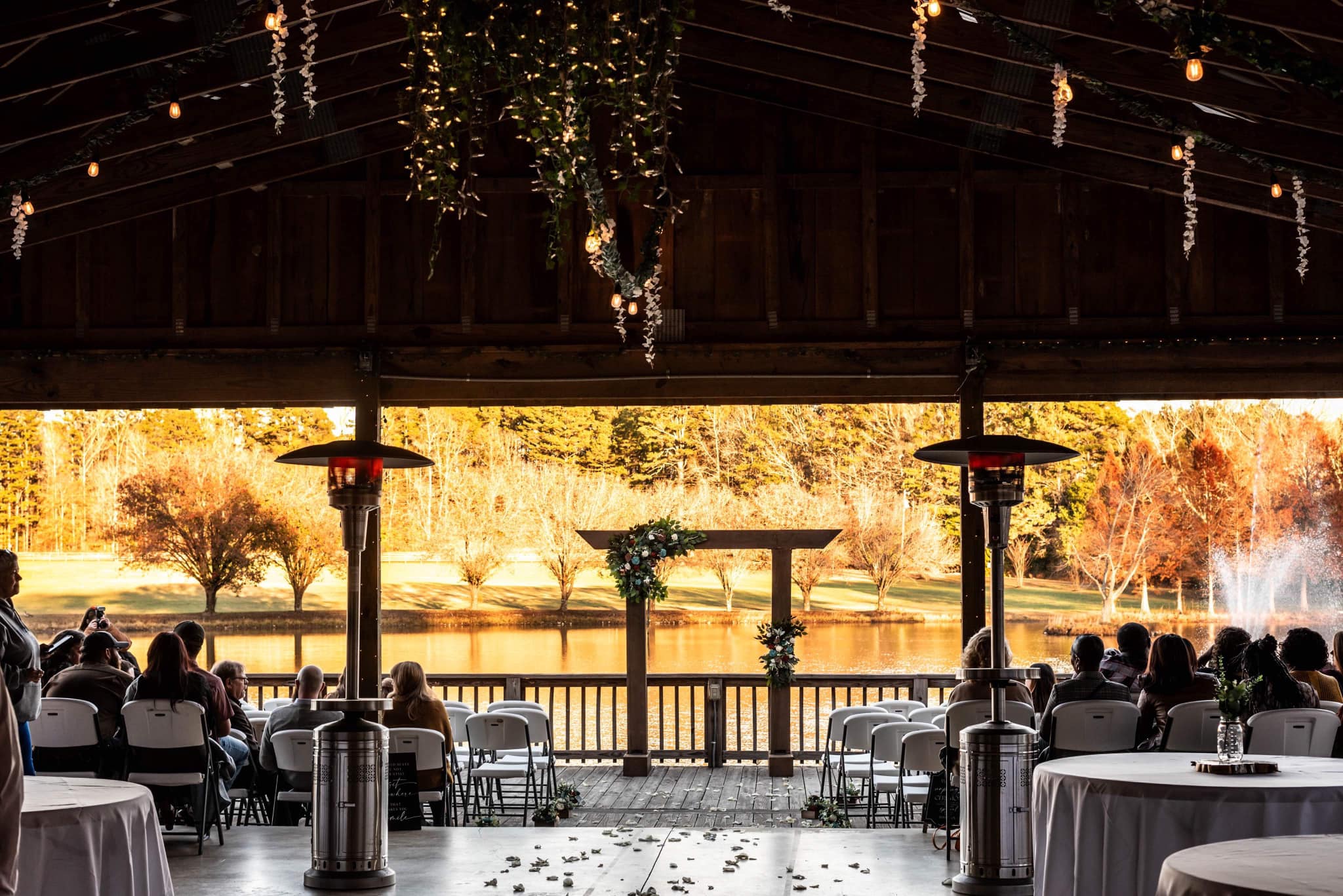 wedding aisle sprinkled with pedals leading to modern arch