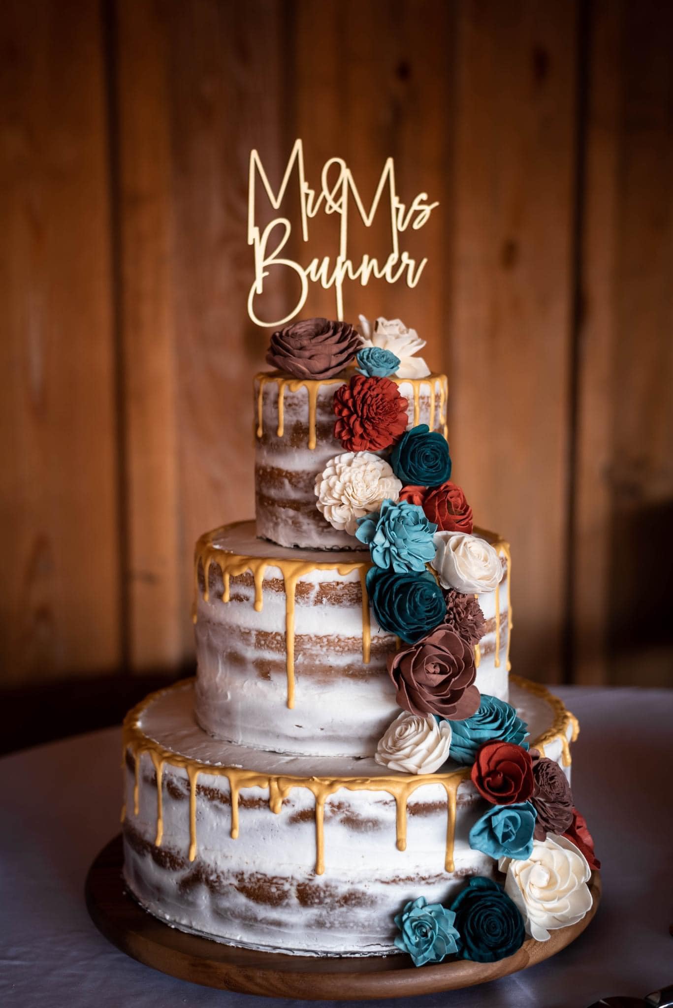 wedding cake with flower and yellow icing drip