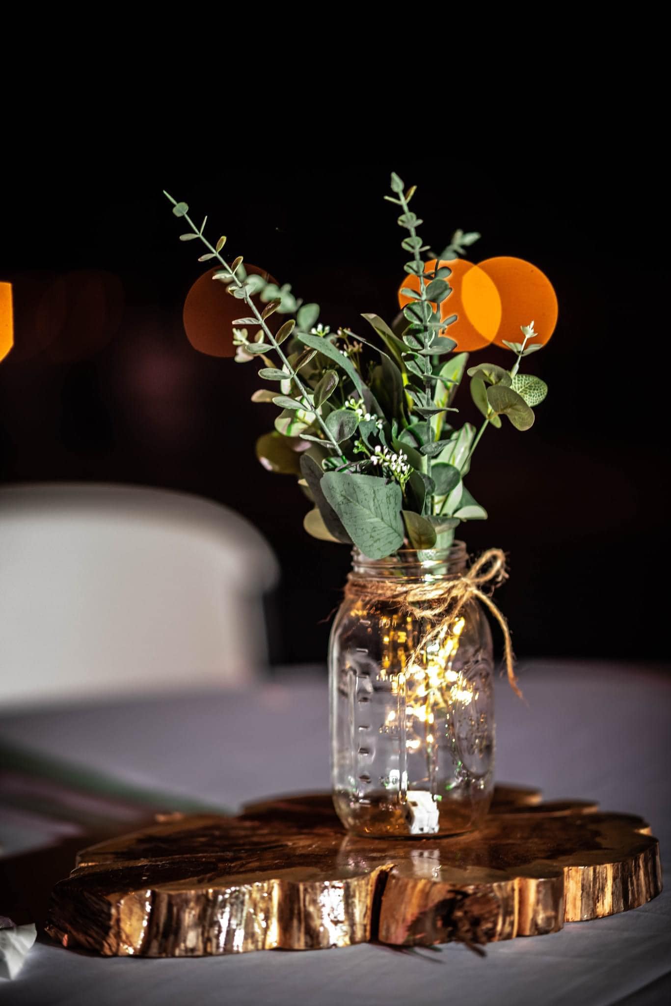 reception table centerpiece with gold accents and greenery