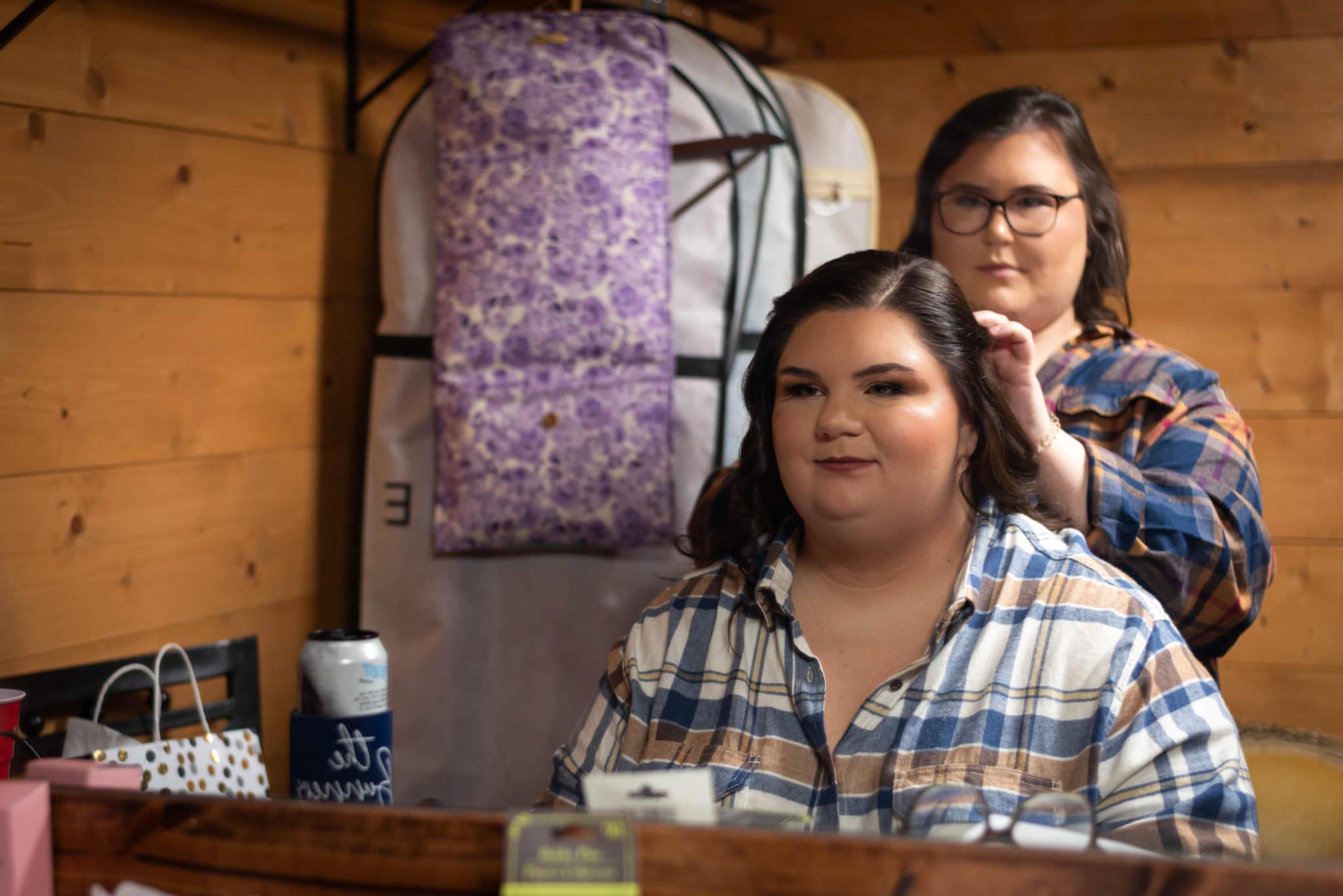 hair stylist clipping bride's hair back