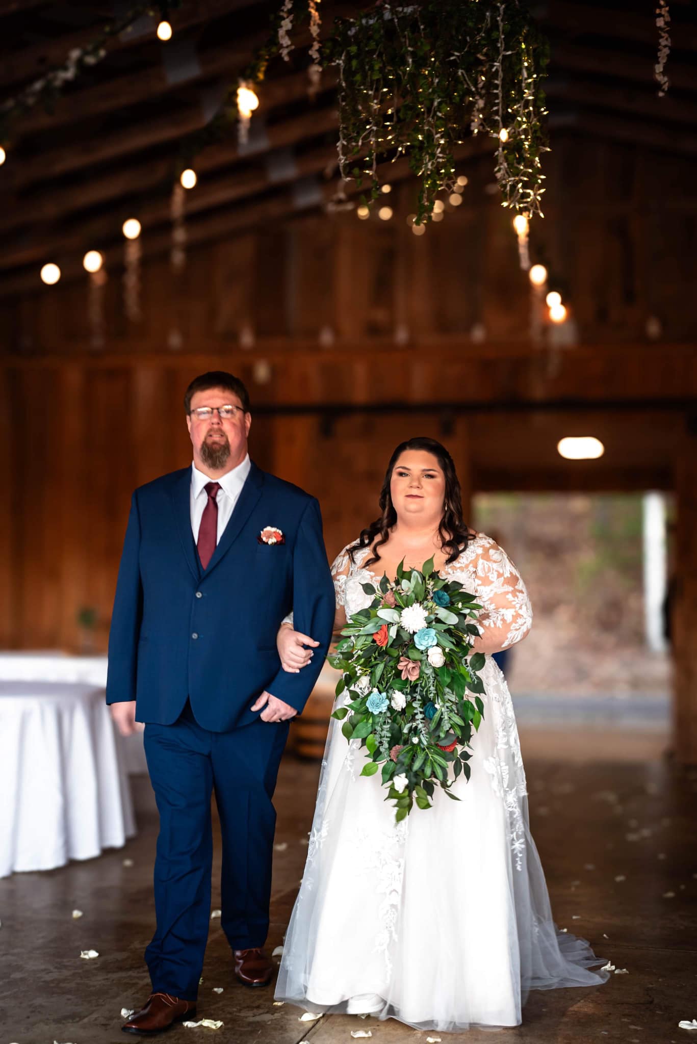 father and bride walking down the aisle