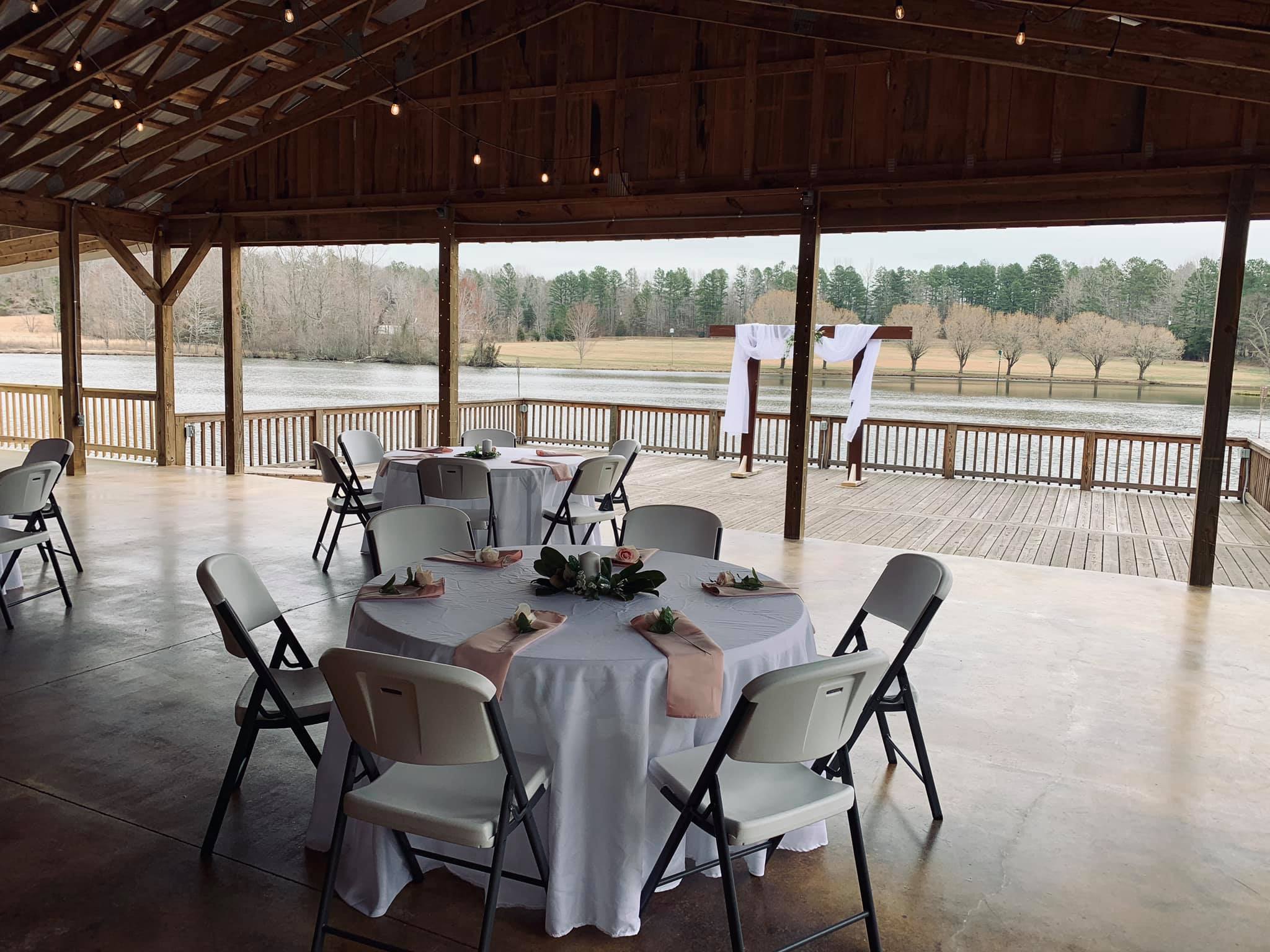wedding reception tables under wooden pavilion